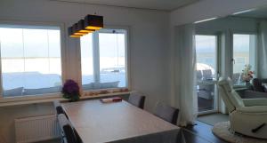 a dining room with a table and chairs and windows at Ailo in Inari
