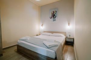 a bedroom with a bed with a picture of a horse on the wall at Casa Gemma in Kos Town