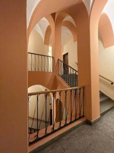 a staircase in a building with a balcony at Pokoje dominikańskie / Dominican rooms in Wrocław
