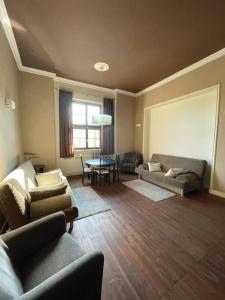 a living room with two couches and a table at Pokoje dominikańskie / Dominican rooms in Wrocław