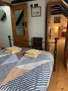 a bedroom with two beds with towels on them at Sea View ,Cottage2 Nc500 in Castletown