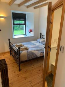 a bedroom with a bed in a room with a window at Sea View ,Cottage2 Nc500 in Castletown
