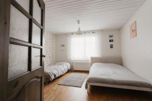 a bedroom with two beds and a window at Vase Holiday Home in Tartu