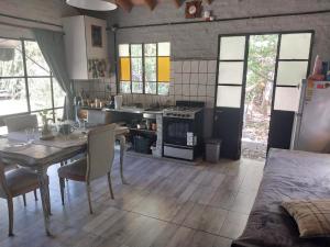 a kitchen with a table and a kitchen with a stove at Loft Verde que te quiero Verde in Mercedes