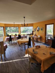 a dining room with tables and chairs and windows at Manoir de la Maison Blanche in Amboise