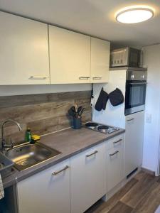 a kitchen with white cabinets and a sink at Entspannung im Grünen in Horn-Bad Meinberg