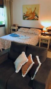 a living room with a couch and a bed at CASA GOLDONI GRAMADO 4 Quartos in Gramado