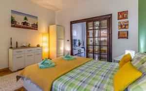 a bedroom with a bed with yellow and green at Apartman 39 in Pula