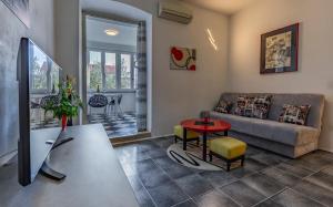 a living room with a couch and a table at Apartman 39 in Pula
