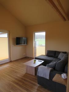 a living room with a couch and a coffee table at Weserberglandalm in Ottenstein