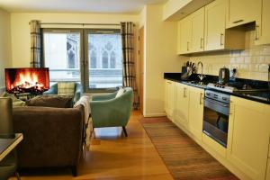 a kitchen and living room with a couch and a stove at Cannon Point BW7 in Fort Augustus