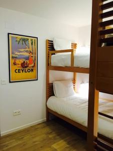 a room with three bunk beds and a picture on the wall at Calle Mayor 21 VUT1222AS in Llanes