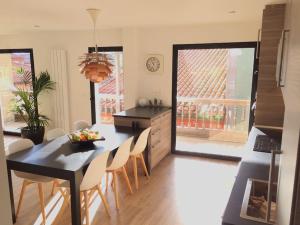 a kitchen and dining room with a table and chairs at Calle Mayor 21 VUT1222AS in Llanes