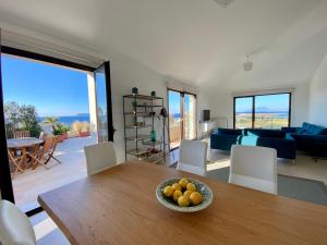 a living room with a table with a bowl of fruit on it at Penthouse Le Isole - Luxury rooftop retreat in Marsala