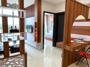 a room with a bed and a room with a desk at 2 Bedroom 02 at Formosa Residence Nagoya Batam by Wiwi in Nagoya