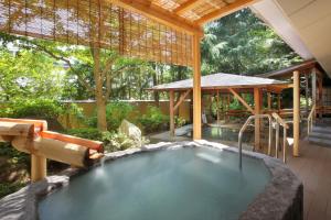 a pool of water in a house with a plunge pool at Azumakan in Nihommatsu