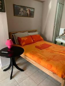 a bedroom with a bed and a table with a lamp at Holidays Pelion studio in Nea Anchialos