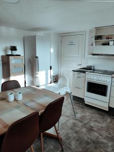 a kitchen with a table and a kitchen with a stove at Landstedet Billund in Billund