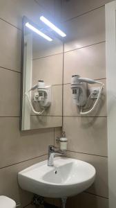 a bathroom with a sink and a mirror at Somnio Hostels in Barcelona +27 photos