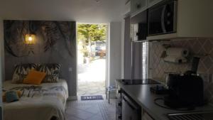 a small kitchen with a bed and a door to a yard at Villa Patrizia in Bastia