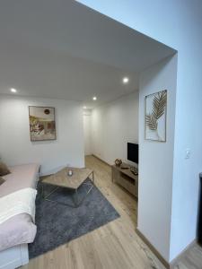 a bedroom with a bed and a table and a tv at Charmant T2, parking privé in Argelès-Gazost