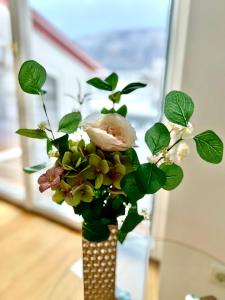 a vase filled with flowers on a table at Gmunden Skyline in Gmunden