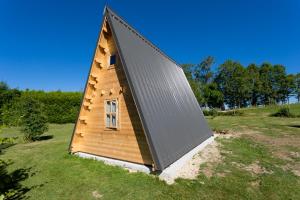 a small wooden house with a pitched roof at Ferme Rony Camp des Découvreurs in Saint-Nizier-du-Moucherotte +3 photos