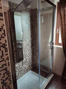 a shower with a glass door in a bathroom at Casa Twins in Bari