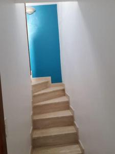 Una escalera en una habitación con una pared azul en Duplex entier 2 personnes centre ville, en Audierne