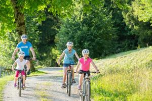 a group of people riding bikes down a dirt road at Grunt Sonek in Mislinja
