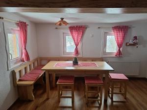 - une salle à manger avec une table, des chaises et des fenêtres dans l'établissement Grunt Sonek, à Mislinja