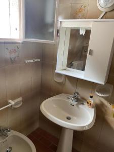 a bathroom with a sink and a mirror at La Casa di Giorgio in Marina di Camerota