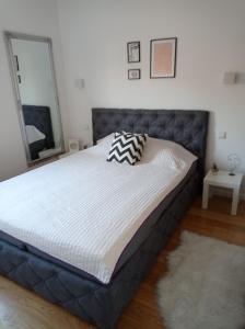 a bed in a bedroom with a large mattress at DAMI in Tuzla