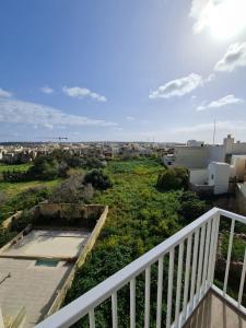 a balcony with a view of a city at Splendid House Victoria Gozo in Victoria