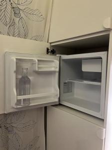 an open refrigerator with a bottle inside of it at Casa de invitados, a pie de playa, en La Torre Verde in El Puerto de Santa María +62 photos