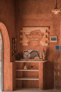 a mural of a man on the wall of a room at Bait Ali in Wadi Rum