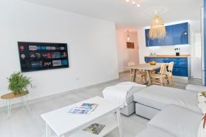 a living room with a white couch and a table at Luxury Buenavista Famara in Famara
