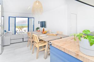 a kitchen and dining room with a table and chairs at Luxury Buenavista Famara in Famara +20 photos