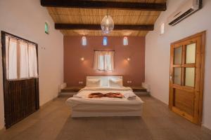 a bedroom with a large bed in a room at Bait Ali in Wadi Rum +126 photos