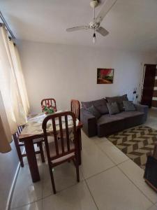 een woonkamer met een tafel, stoelen en een bank bij Apto Richard Shopping in Campos dos Goytacazes +19 foto's