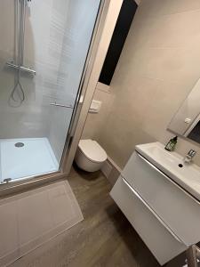 a bathroom with a shower and a toilet and a sink at Cocon Cosy Nancy centre in Nancy