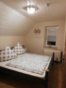 a bedroom with a large bed with pillows on it at Haus Oldenburg in Lauterecken