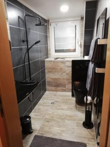 a bathroom with a black toilet and a sink at Haus Oldenburg in Lauterecken