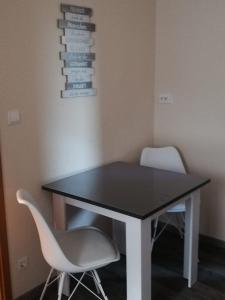 a table and two chairs in a room at Haus Oldenburg in Lauterecken +7 photos
