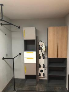 a room with a cabinet and a shelf with shoes at Les Terrasses d Isola 2 pièces 4 personnes in Isola 2000