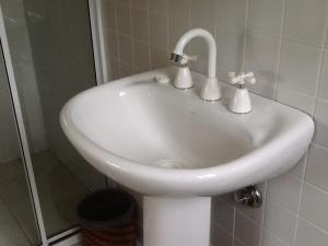 a white sink in a bathroom with a shower at Glen Waverly Farmstay in Glen Innes