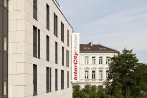 a white building with a sign on the side of it at IntercityHotel Bonn in Bonn