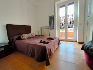 a bedroom with a bed and a large window at Casa Francesca zona Gemelli in Rome