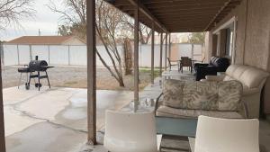 a living room with a couch and chairs on a patio at Sun Angel House #2 Pahrump in Pahrump
