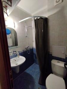 a bathroom with a sink and a toilet and a shower at Studio Zora in Burgas City